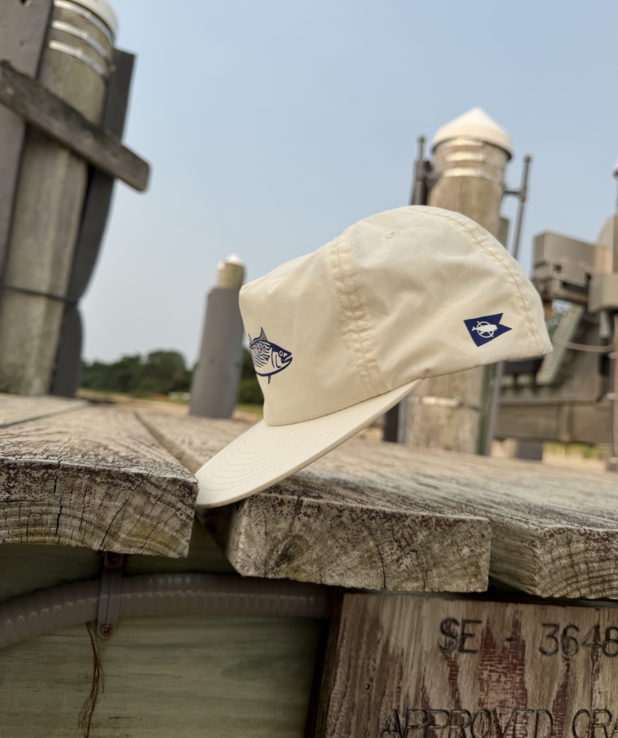 Cream Bonito Bar surf hat photographed on a Nantucket waterfront.